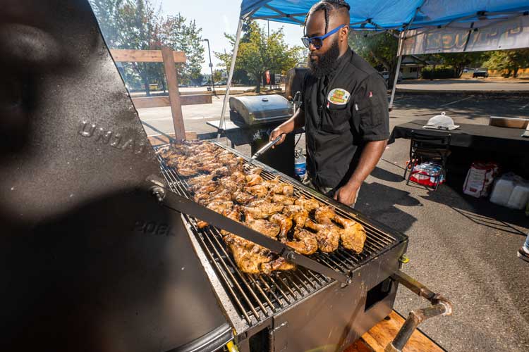 tevin campbell, jerk an tingz chef, bbqing jerk chicken in their catering pop up kitchen outside of 507 taproom in yelm washington.